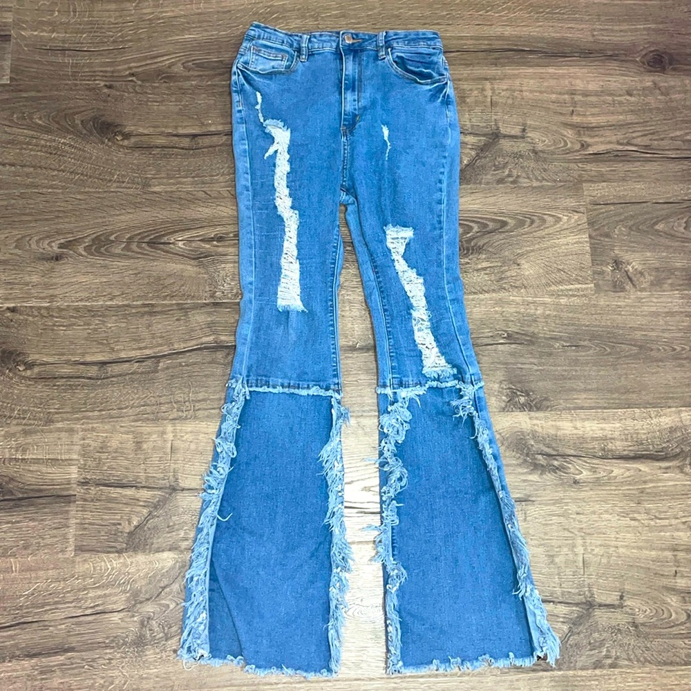 Frayed flare bell bottom ripped blue jeans